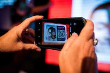 Person scanning the VEM CA QR Code